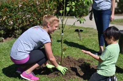 Lauren Wood with Child planting a tree